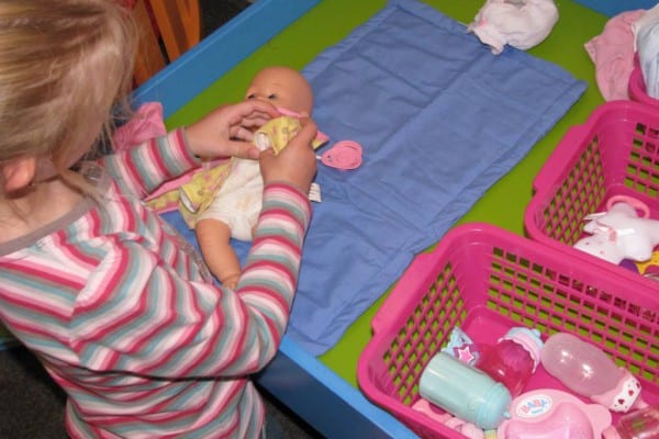 baby doll playing with toys
