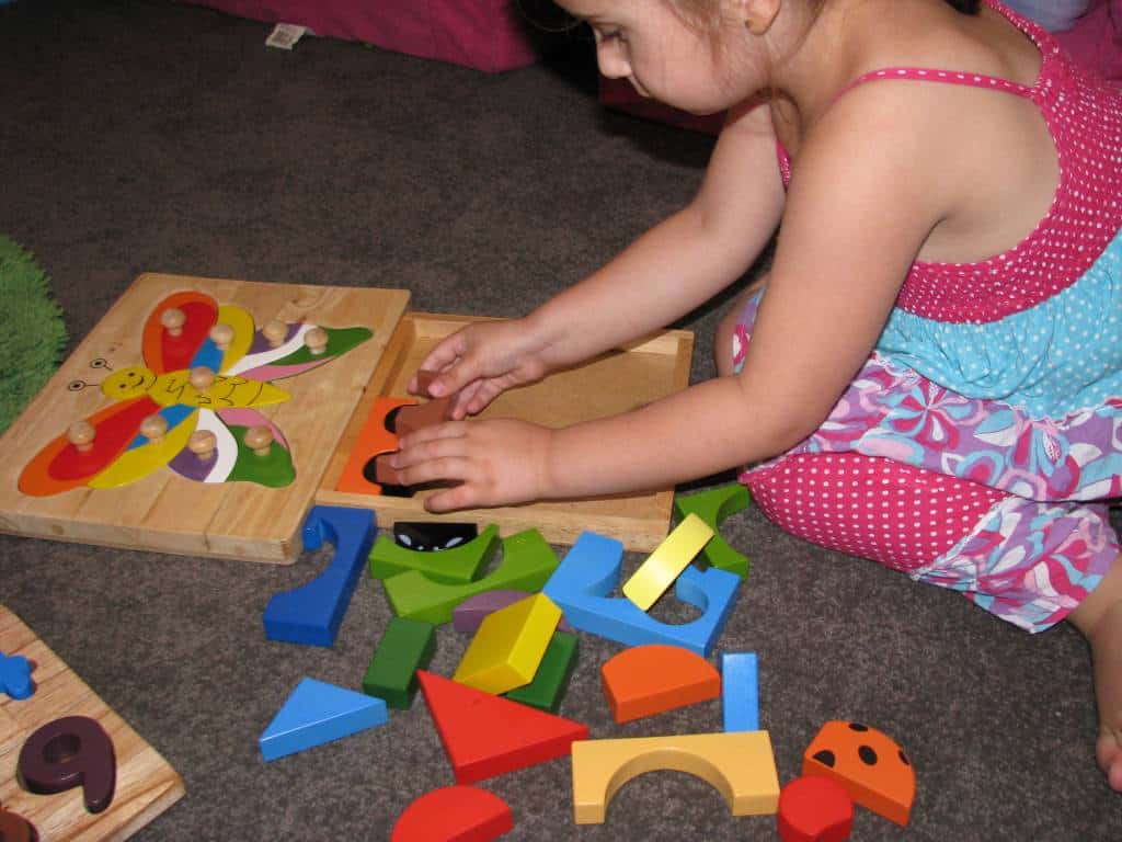 Image result for child playing with puzzle